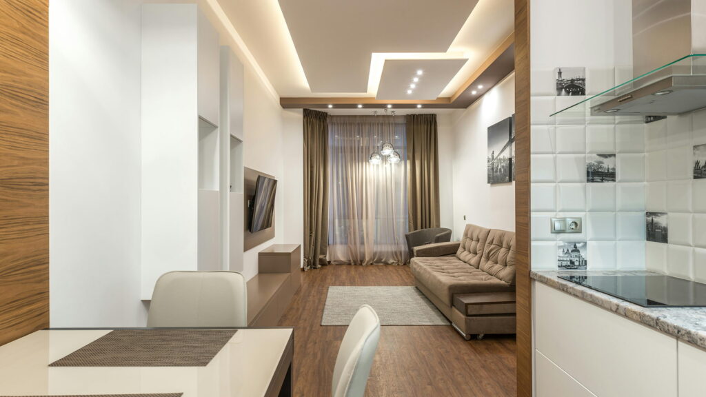 modern false ceiling design with cove lighting and recessed LED for living room interior design in Bangalore by Wooden Sign Interiors
